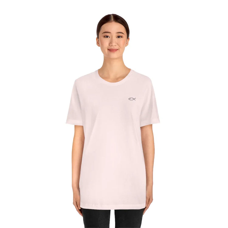 Woman wearing a white Christian fish symbol t-shirt, faith-inspired minimalist design