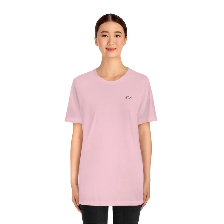 Woman wearing light pink Christian t-shirt with small Ichthys fish symbol on chest