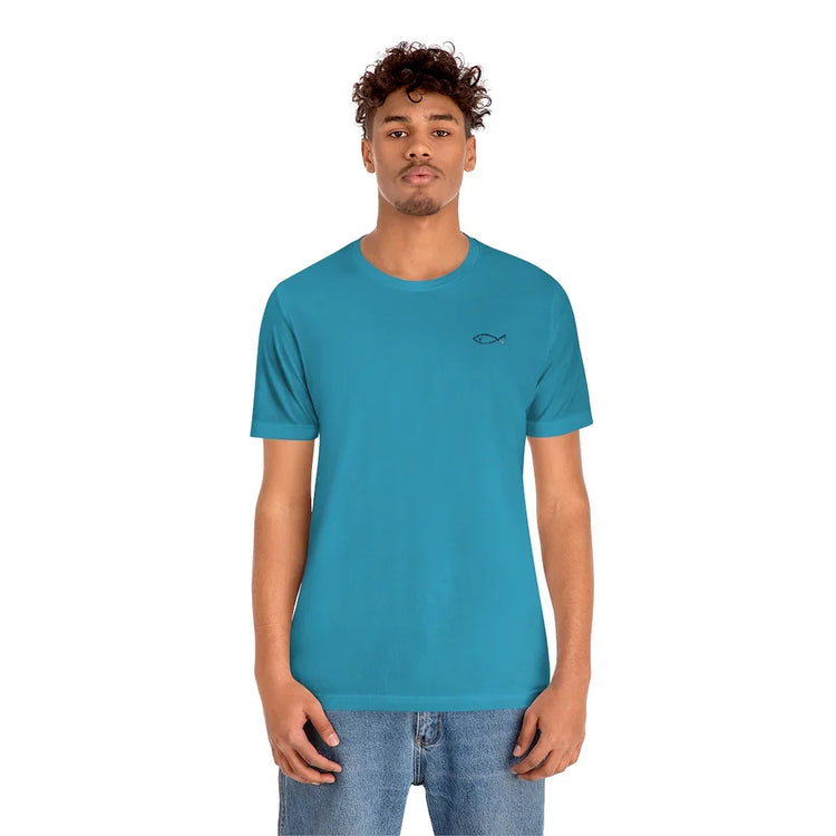 Man wearing teal Christian t-shirt with small fish symbol and blue jeans, white background
