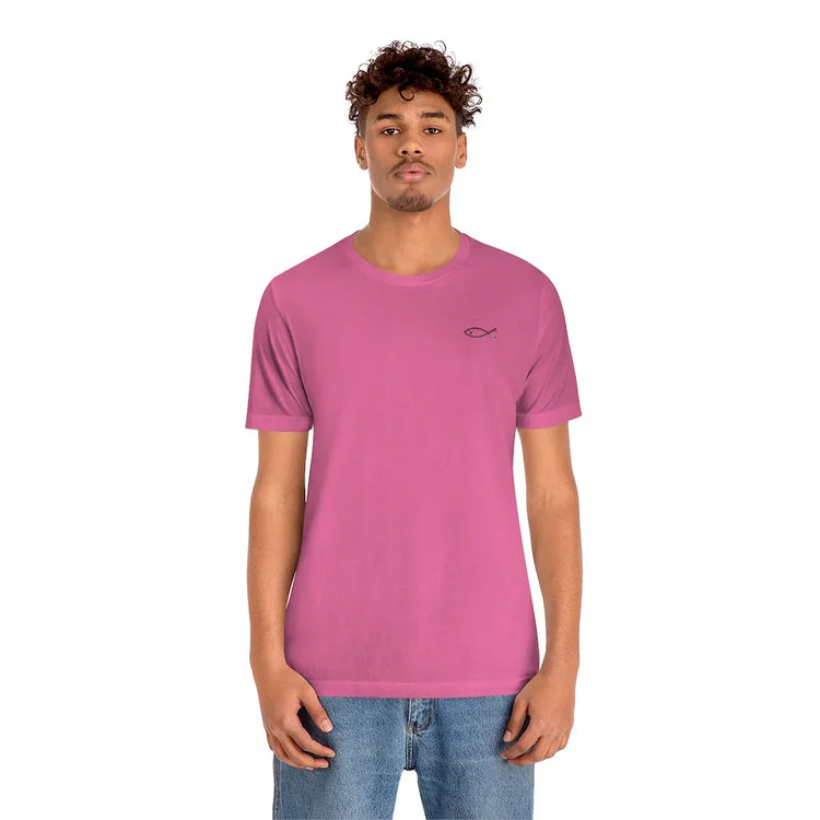 Man wearing a pink Christian t-shirt with an Ichthys fish symbol, faith-inspired clothing