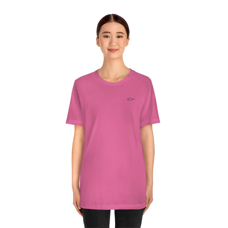 Woman wearing a pink Christian t-shirt with small Ichthys fish symbol on chest